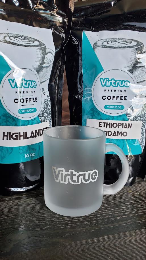 Virtrue coffee mug with virtrue coffee bags behind it.