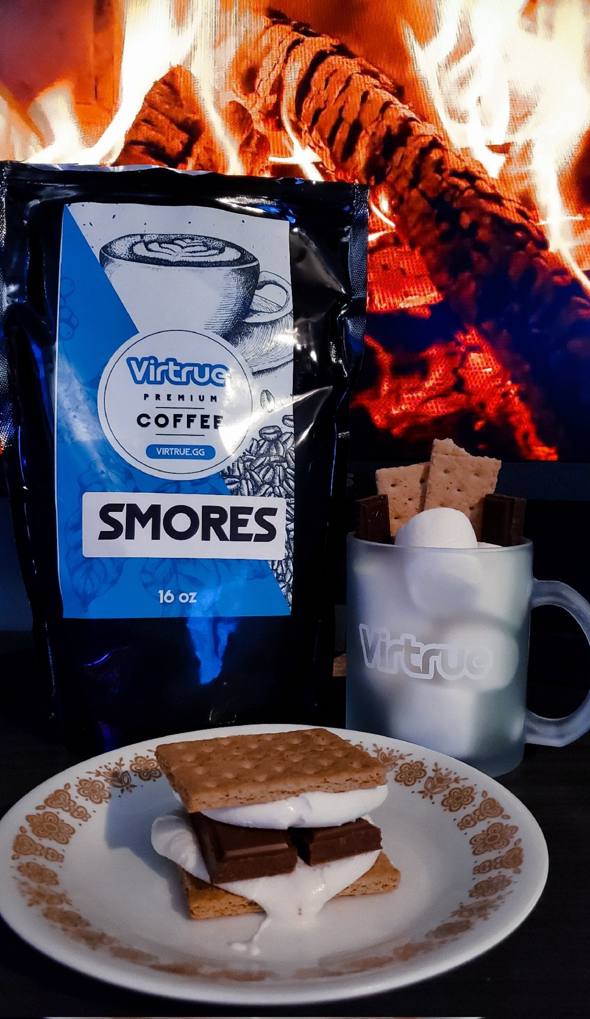 Virtrue coffee mug with a bag of smores coffee in front of a fire with a smore on a plate