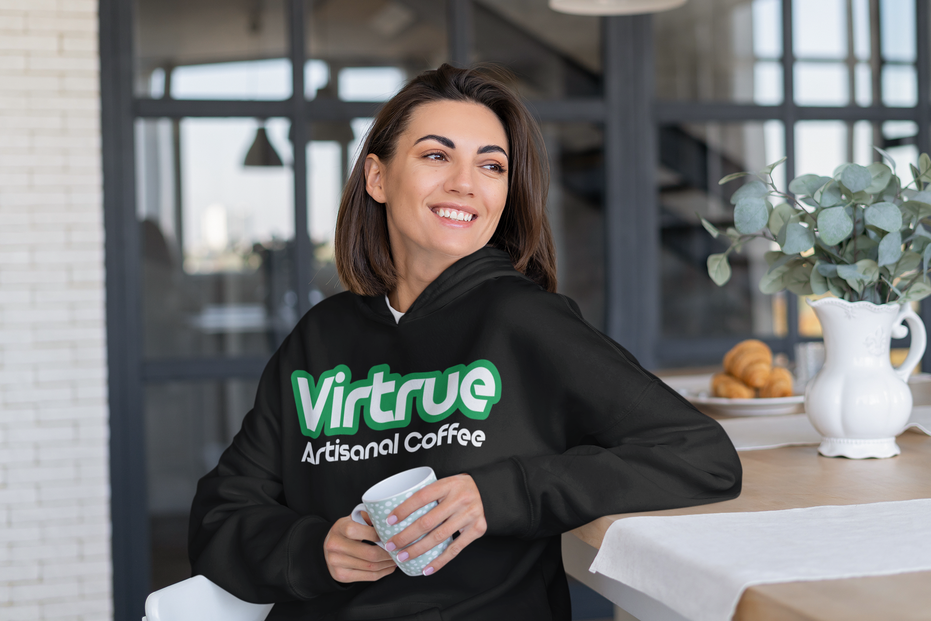 Virtrue Coffee sweatshirt on a woman drinking coffee