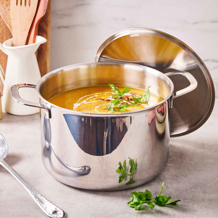 Homemade soup simmering in an Alva stainless steel stock pot on a stovetop