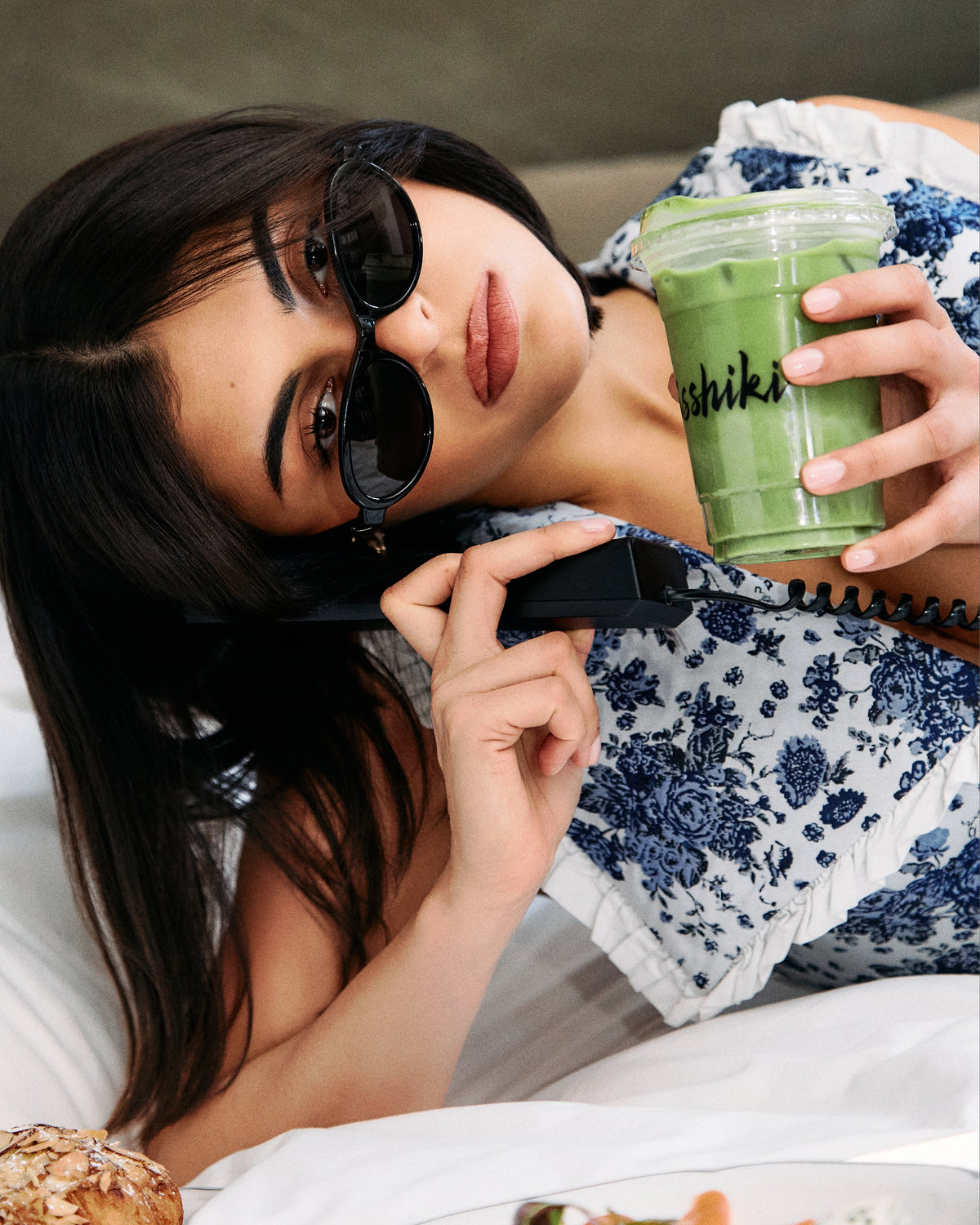 Woman enjoying a cold green matcha drink outdoors