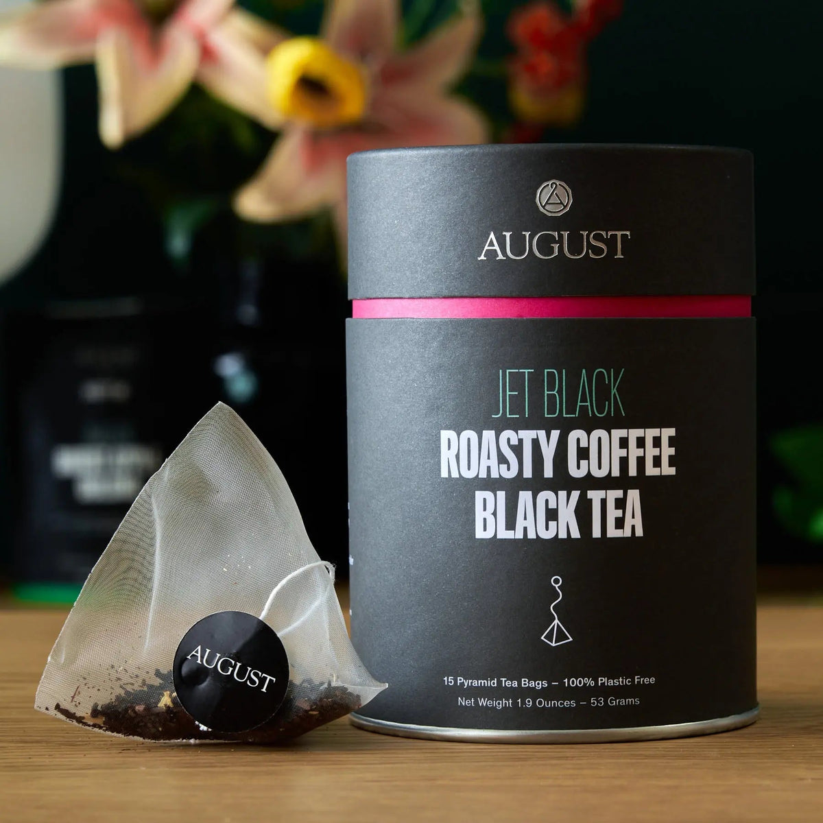 August Jet Black coffee and hazelnut black tea tin displayed with individual pyramid tea bag
