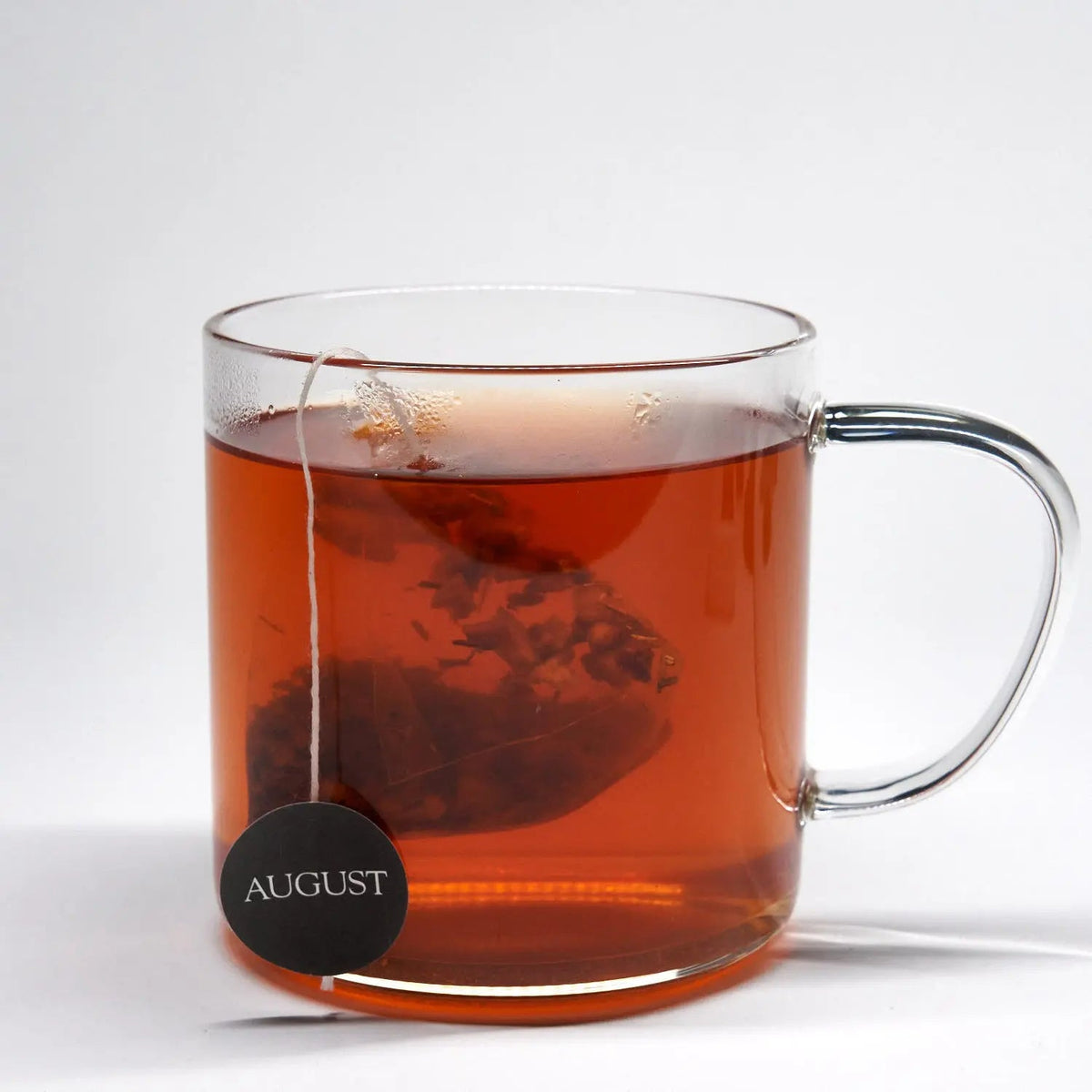 Glass mug filled with brewed August Psychocandy Pumpkin Caramel Rooibos Tea