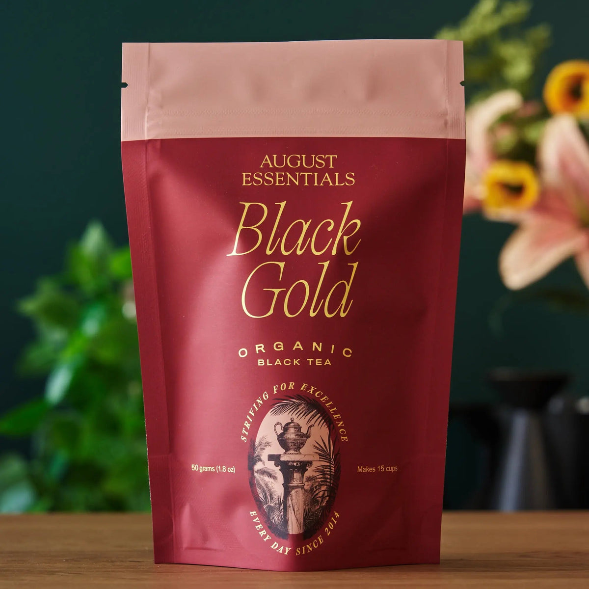 August Essentials Black Gold organic Yunnan loose leaf black tea in premium red pouch
