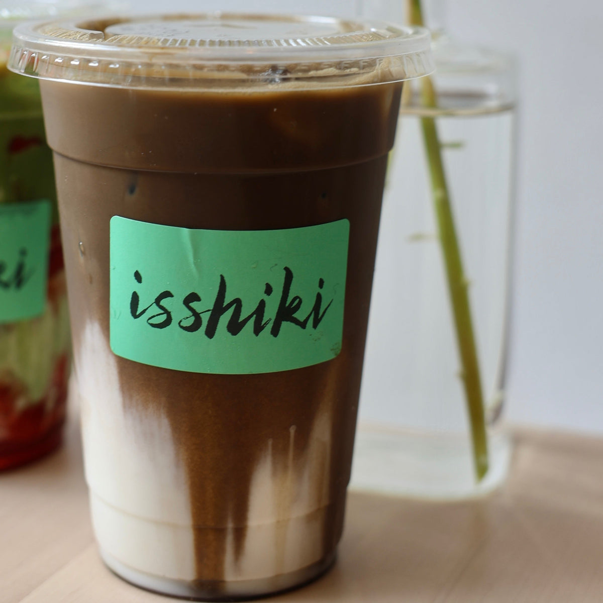 Iced Hojicha latte with milk and roasted Japanese green tea served in a clear glass