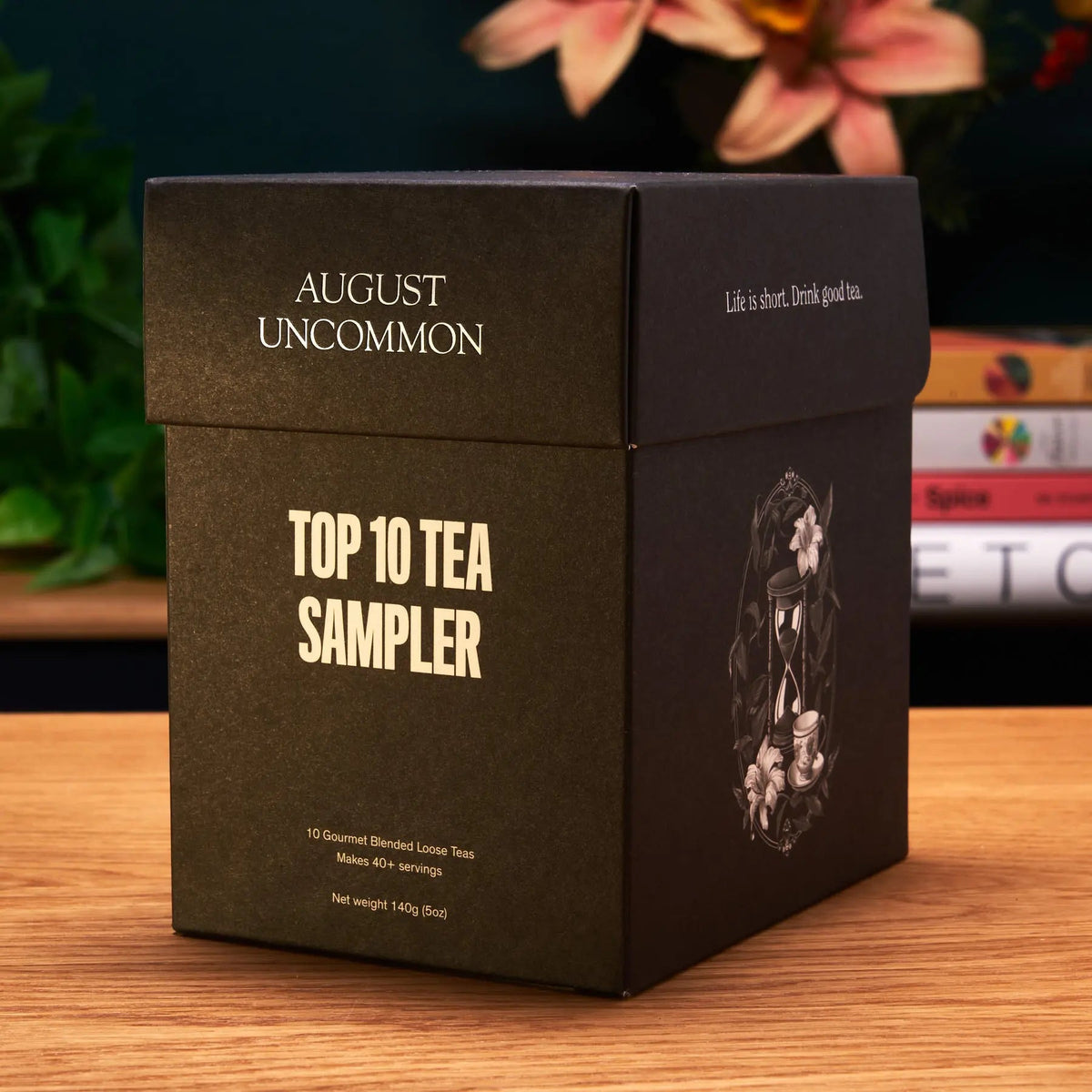 August Uncommon Tea Top 10 loose leaf tea sampler in premium black gift box on wooden table