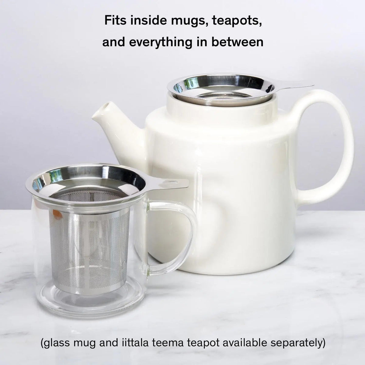 Silver tea infuser resting on black silicone coaster after steeping
