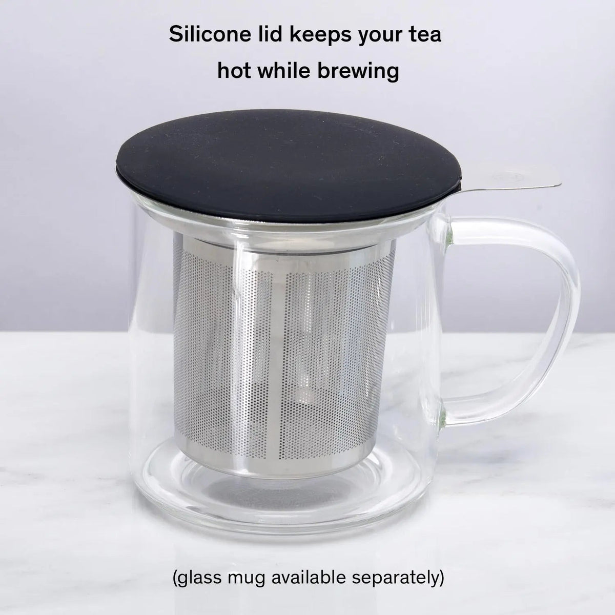 Silver stainless steel tea infuser placed inside clear glass mug
