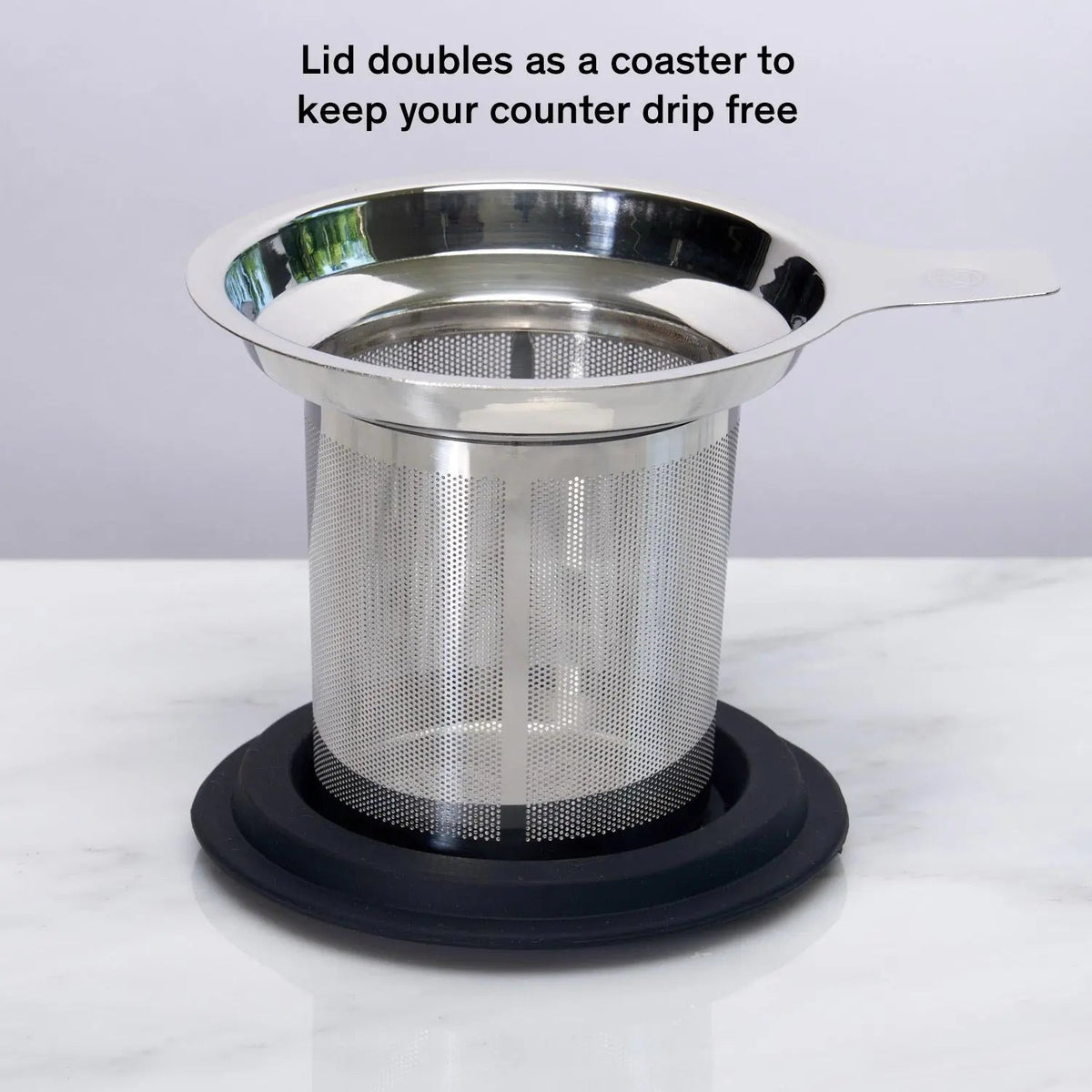 Silver stainless steel tea infuser in glass mug with black silicone lid
