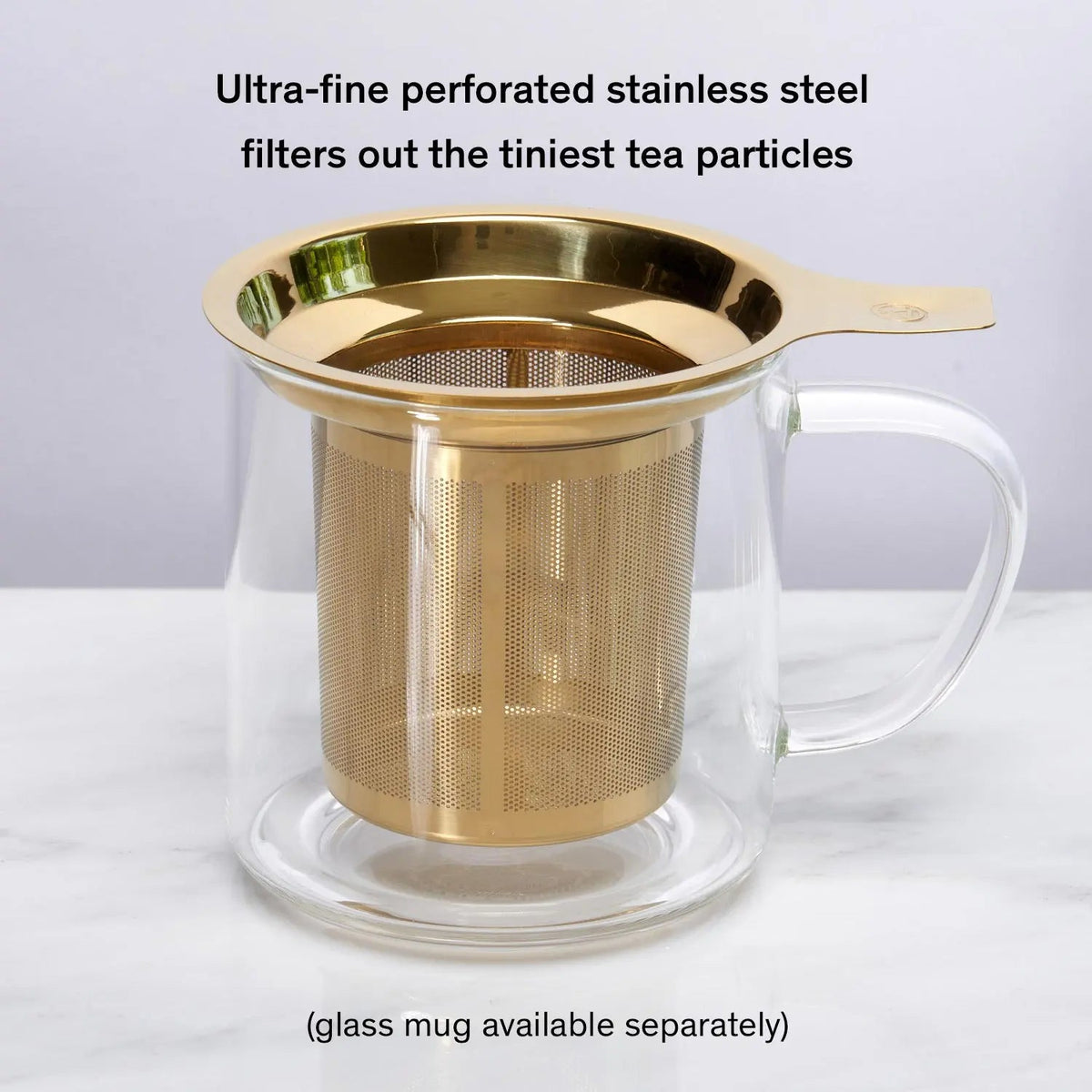Gold stainless steel micro-mesh tea infuser inside glass mug
