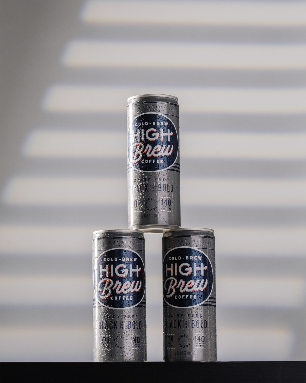 High Brew Black & Bold Cold Brew Coffee cans stacked together in a minimalist display