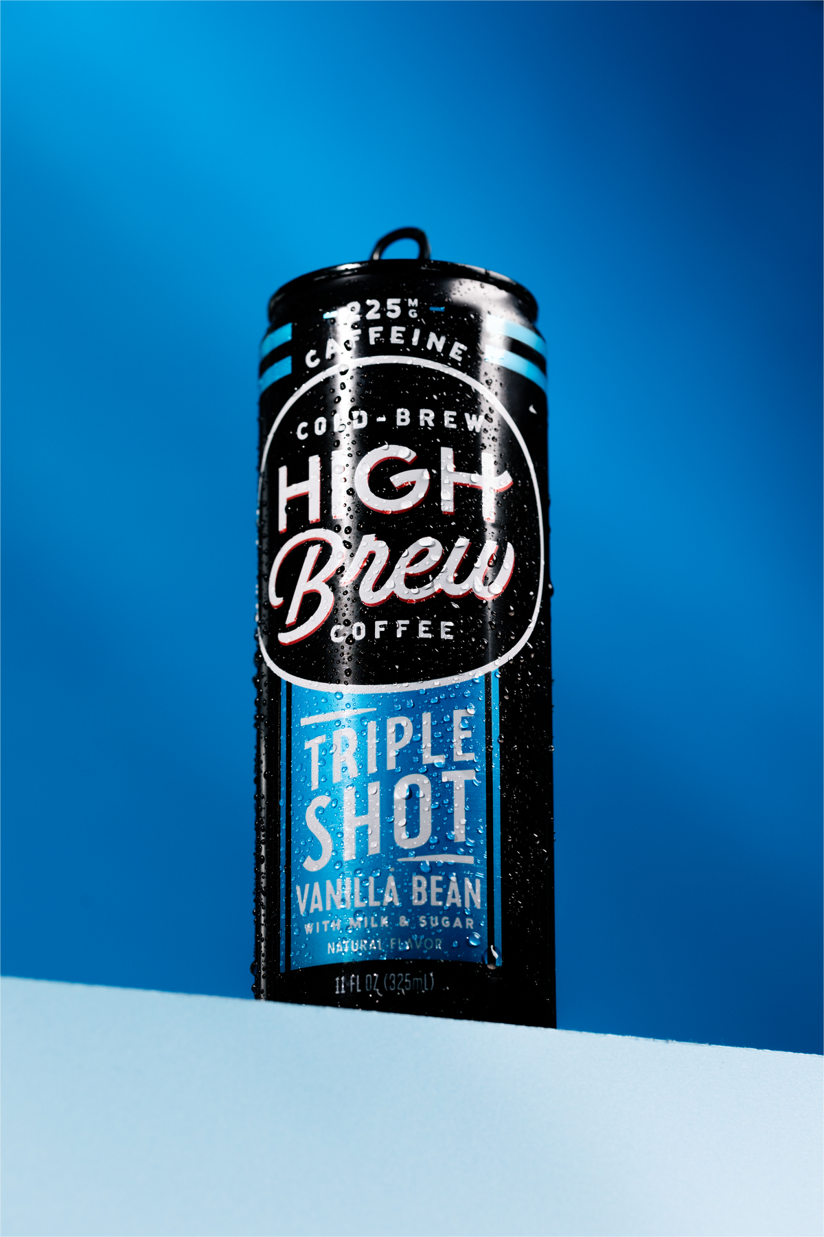 High Brew Vanilla Bean Triple Shot Cold Brew Coffee black and blue can against blue background
