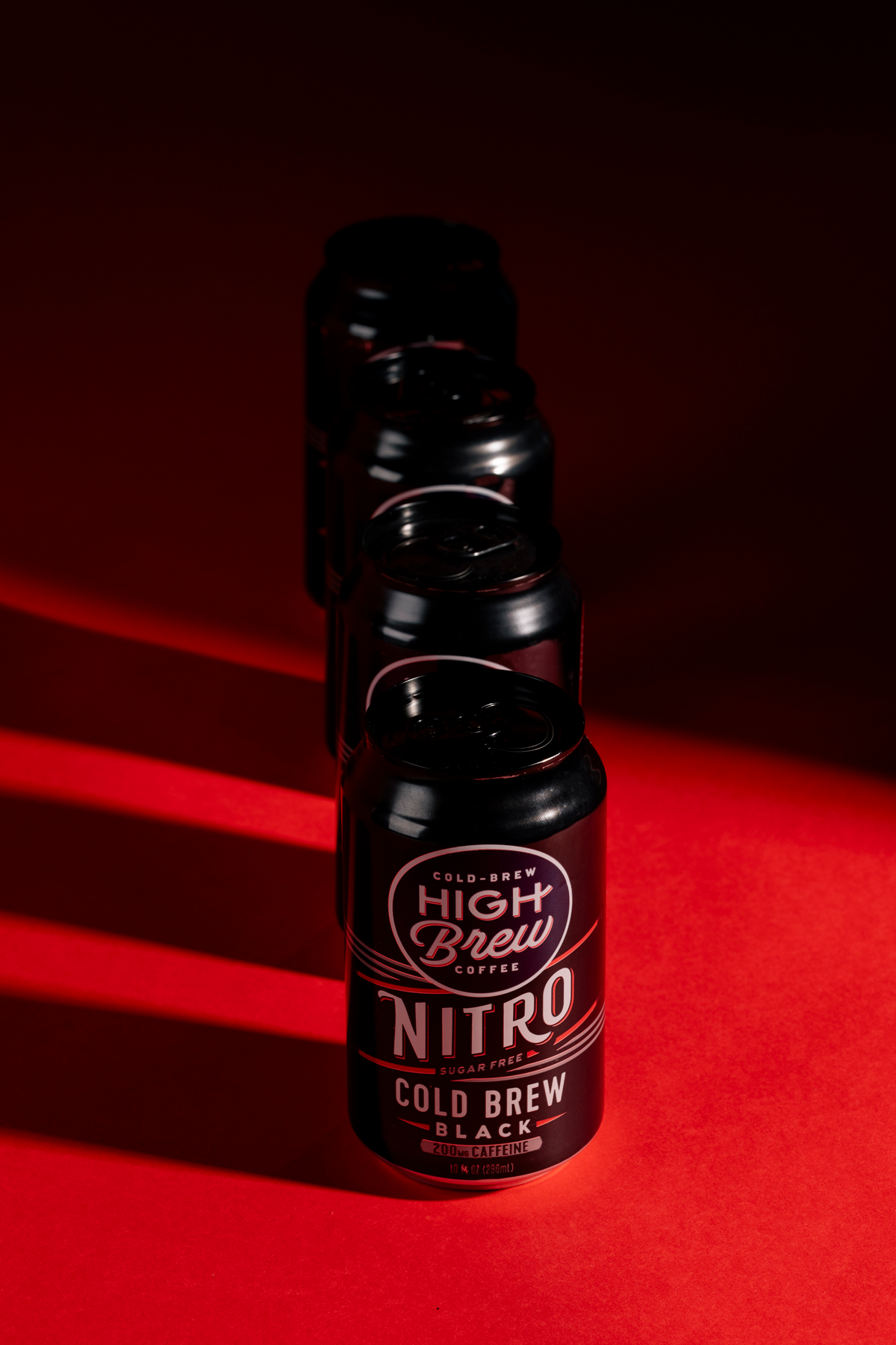High Brew Nitro Black Cold Brew Coffee can photographed against dramatic red and black lighting