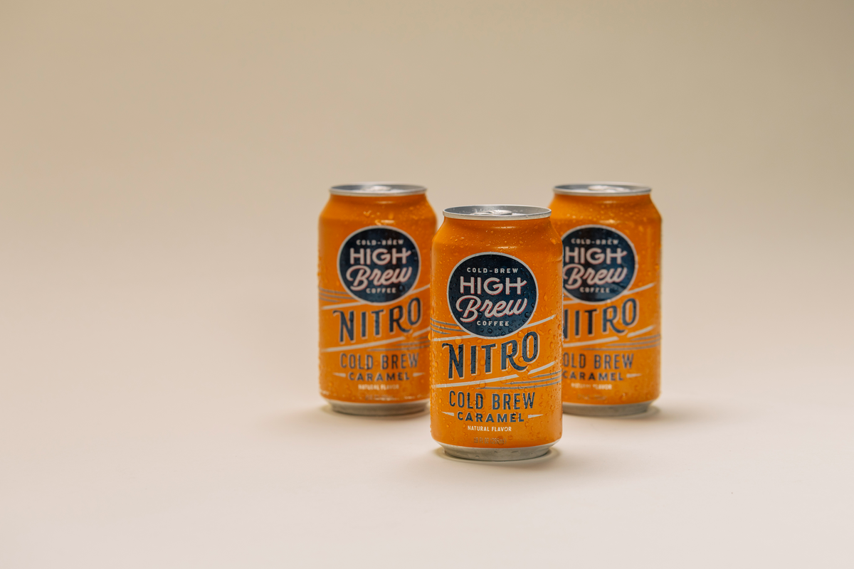 Three orange High Brew Nitro Caramel Cold Brew Coffee cans displayed together