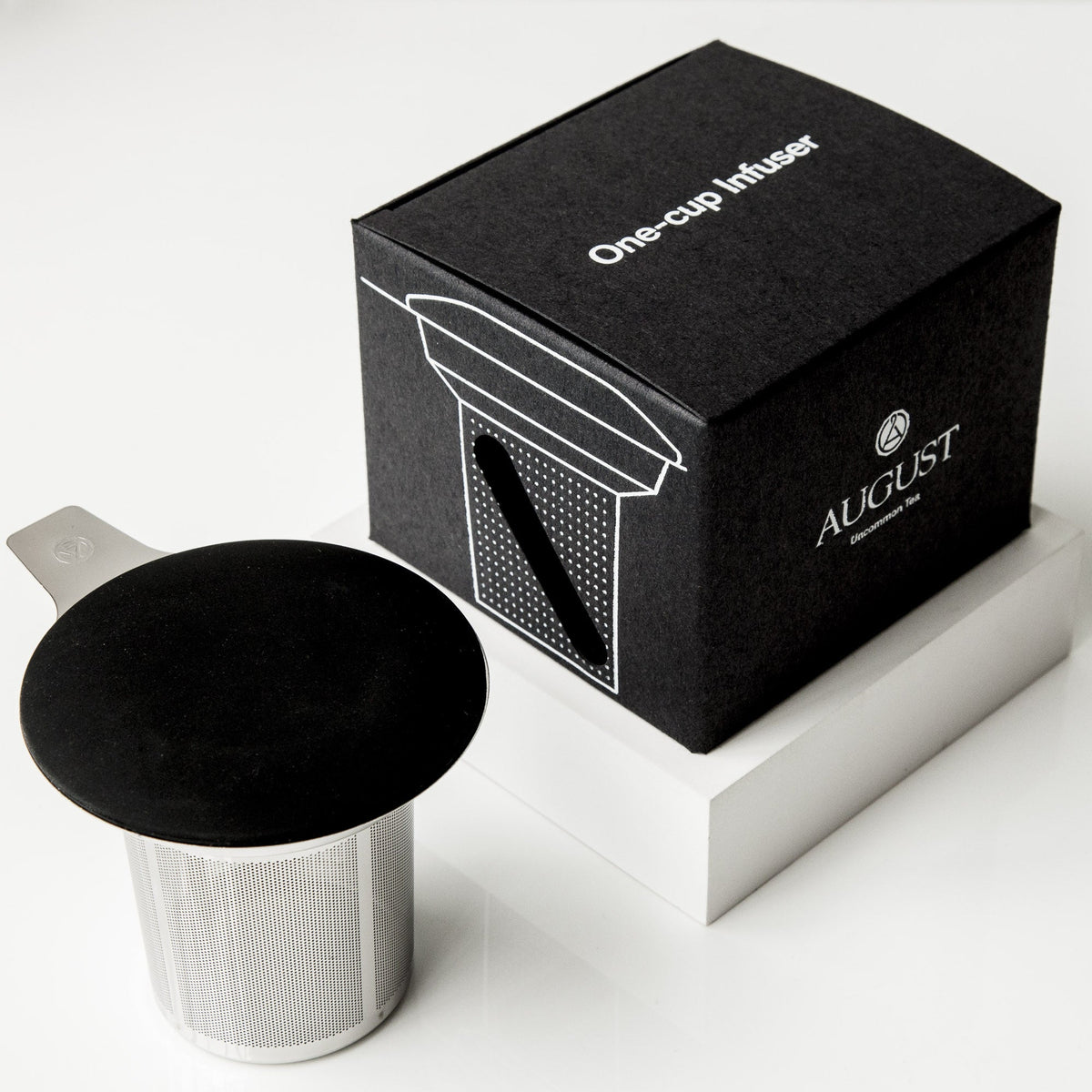 August One Cup tea infuser and silicone lid beside black product box
