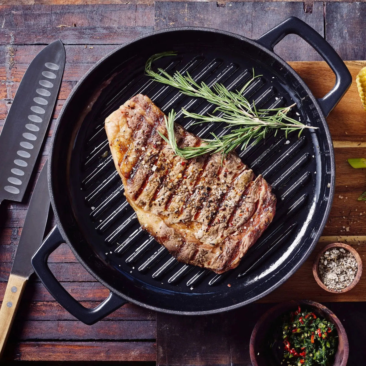 Steak searing on the raised ridges of an Alva enameled cast iron grill pan