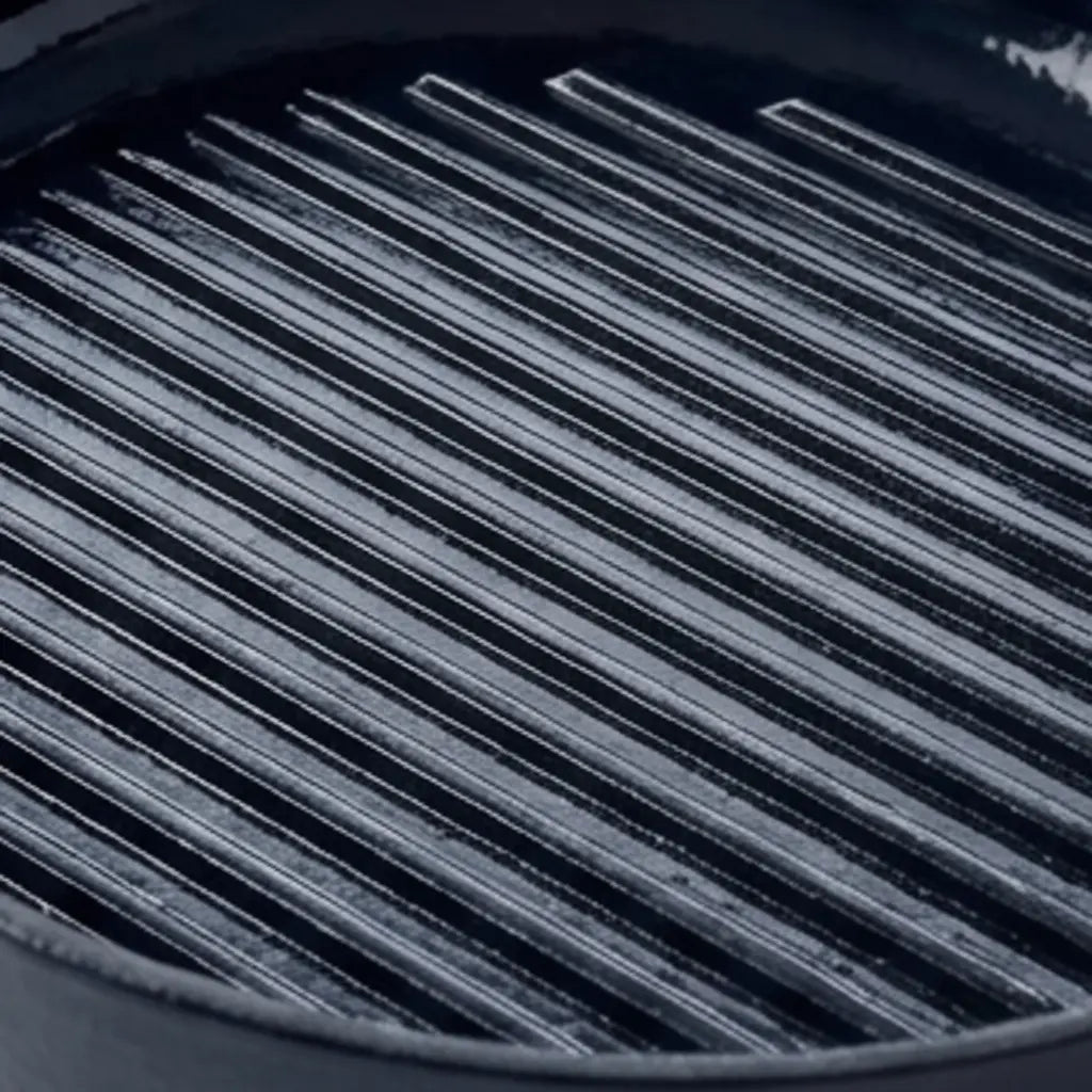 Close-up of the raised cooking ridges inside an Alva enameled cast iron grill pan