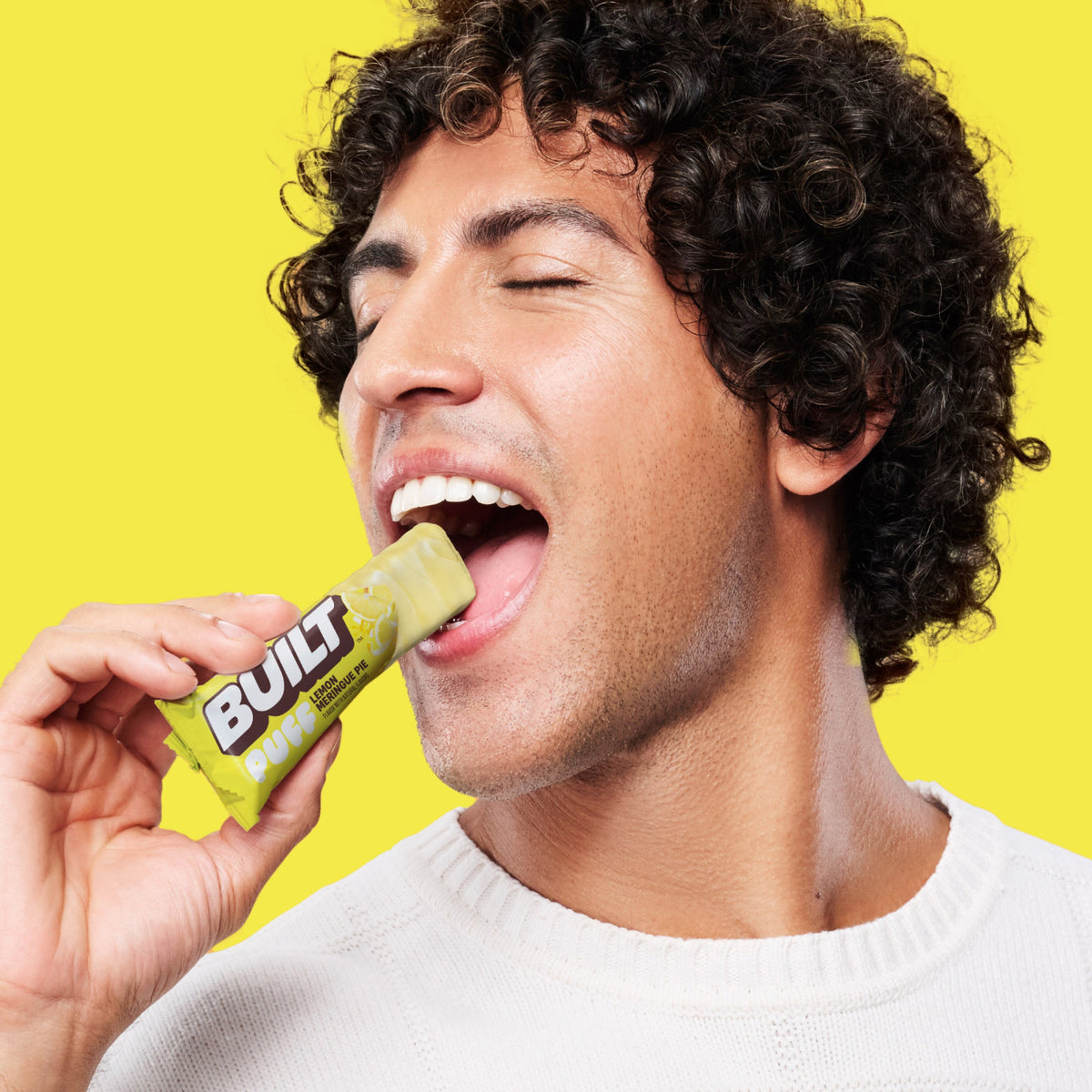 Man eating a BUILT Lemon Meringue Pie Puff