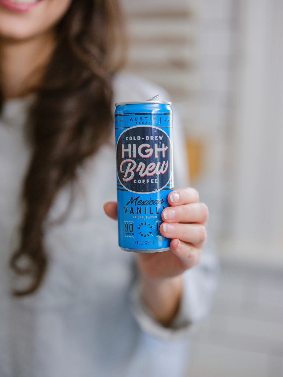 Person holding a blue High Brew Mexican Vanilla Cold Brew Coffee can