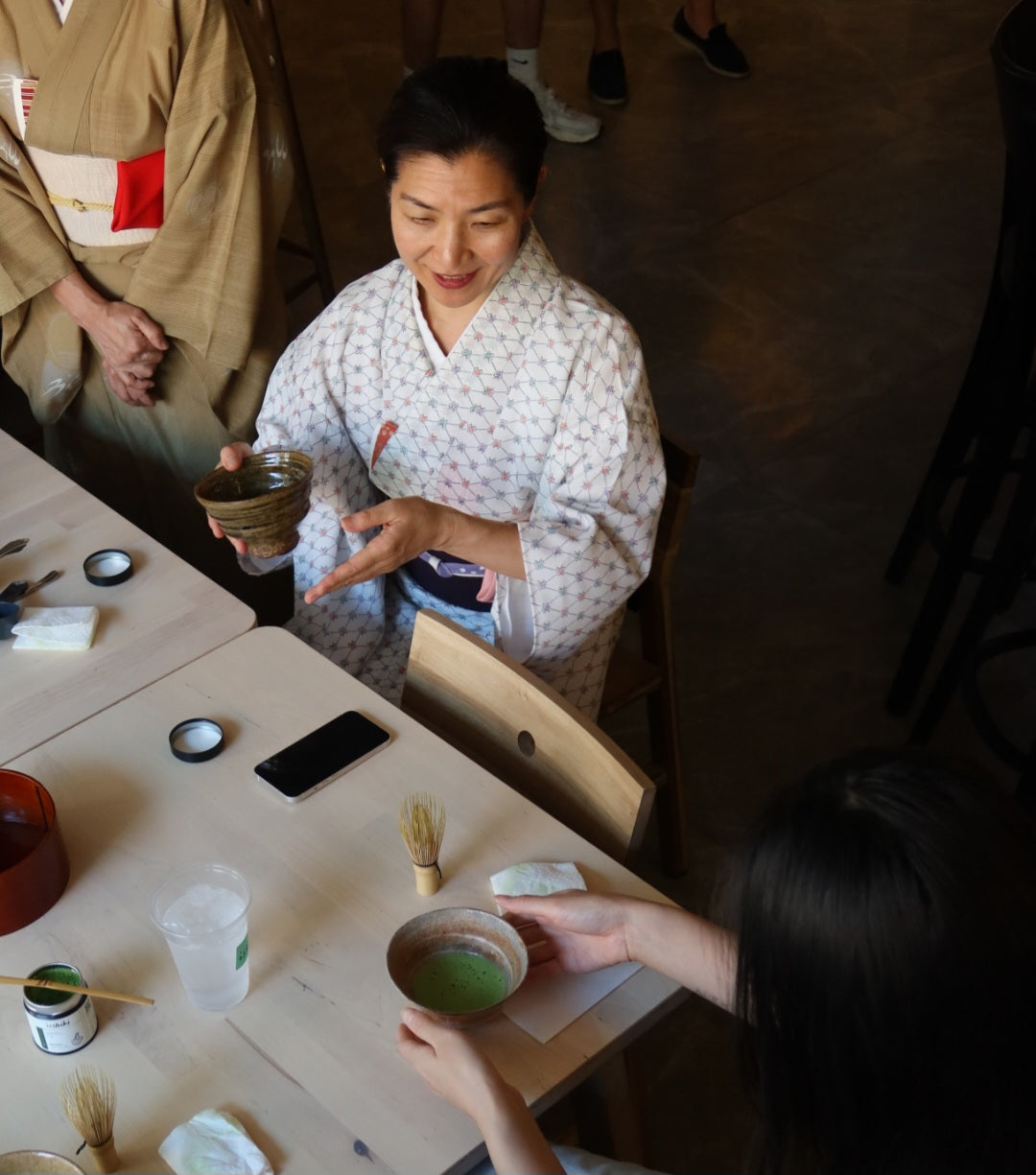 Japanese tea preparation with traditional utensils and matcha accessories