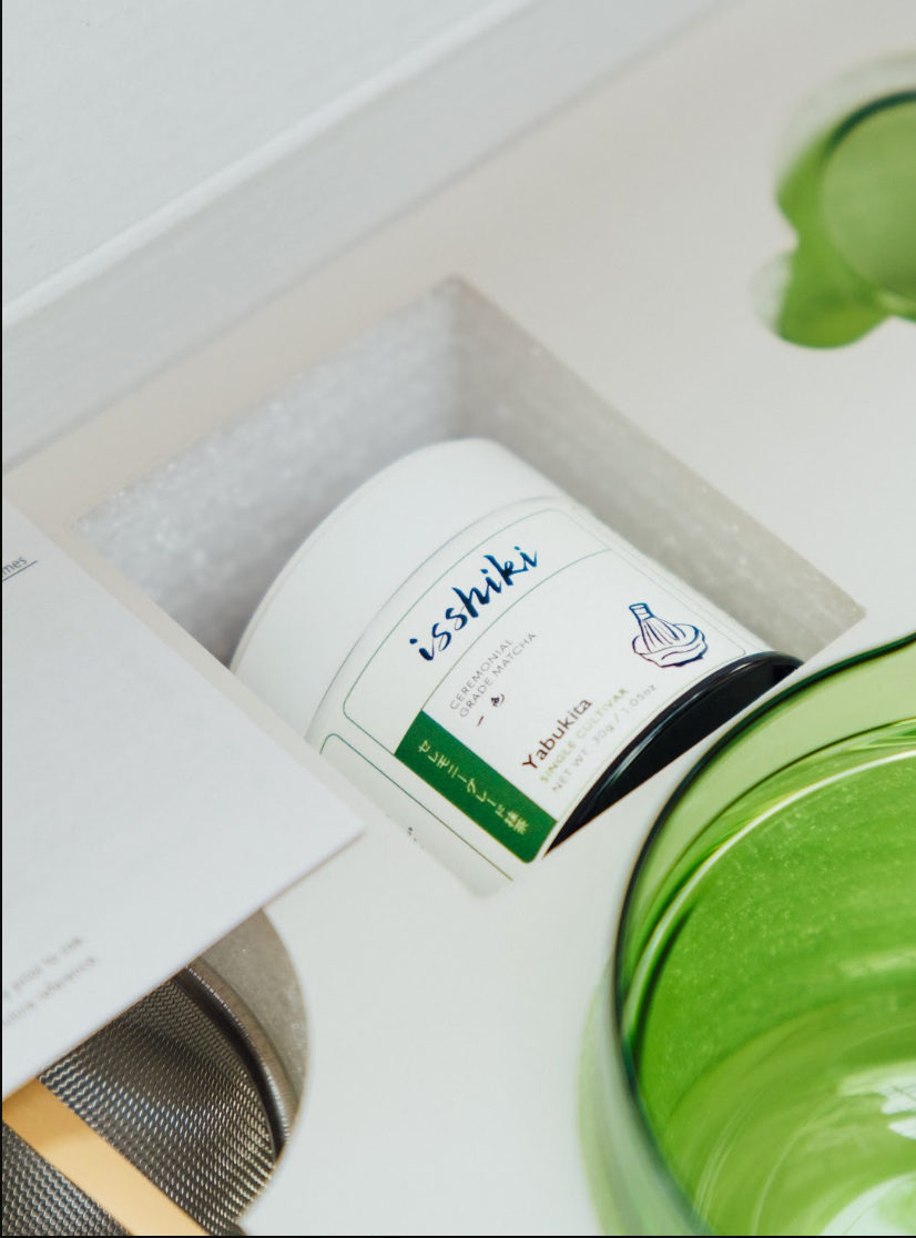 Close-up of Isshiki Yabukita matcha tin and green matcha bowl inside starter kit packaging
