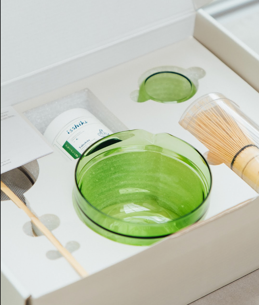 Overhead view of Isshiki Hario matcha starter kit with prepared green matcha in glass bowl