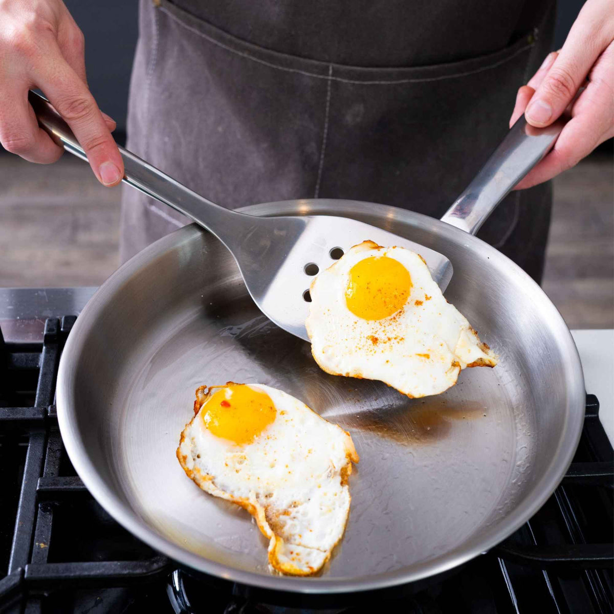 Eggs frying in an Alva stainless steel frying pan on a stovetop