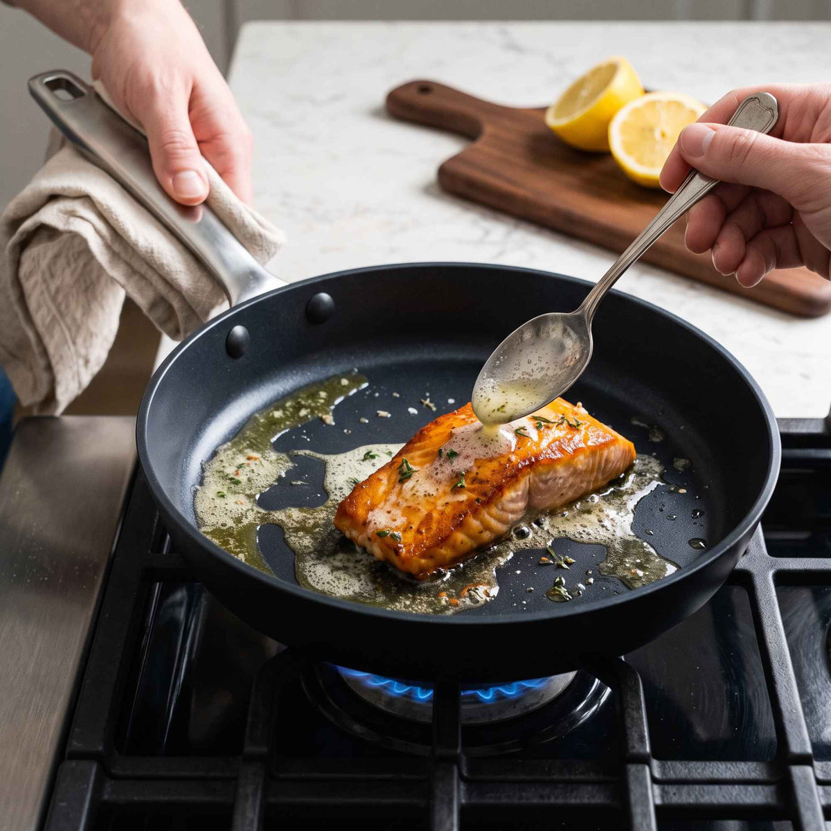 Fish being cooked in an Alva ceramic nonstick frying pan with a stainless steel handle