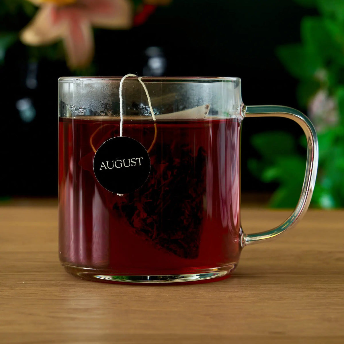 Glass mug filled with freshly brewed August Jet Black black tea
