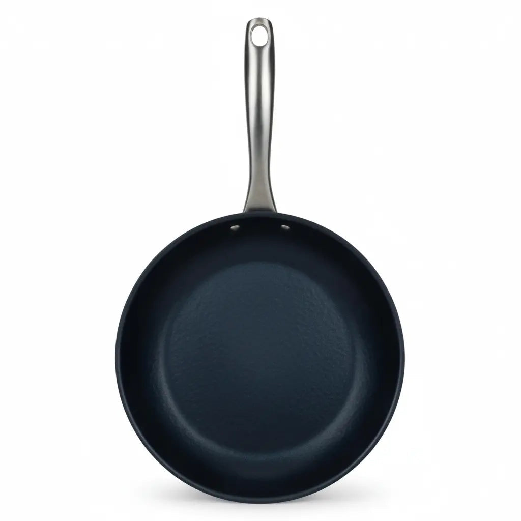 Top-down view of an Alva Black Angus carbon steel frying pan with stainless steel handle
