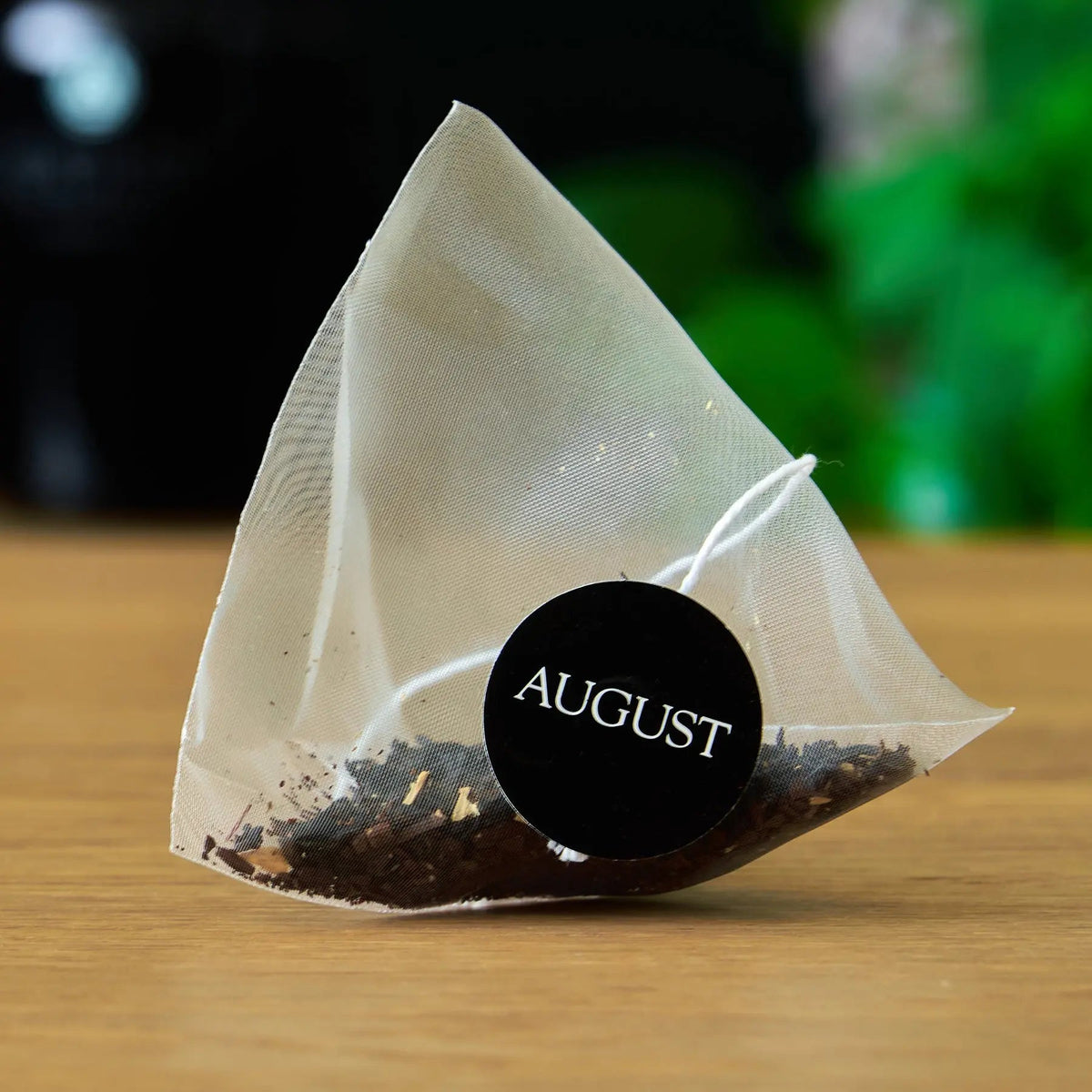 Pyramid tea bag containing August Jet Black coffee-inspired black tea blend
