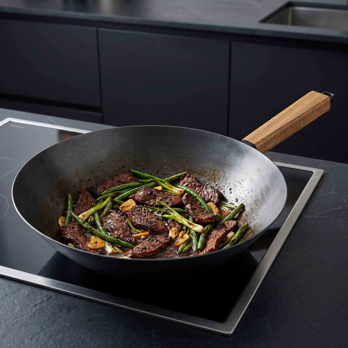Vegetables being stir-fried in an Alva carbon steel wok on an induction cooktop