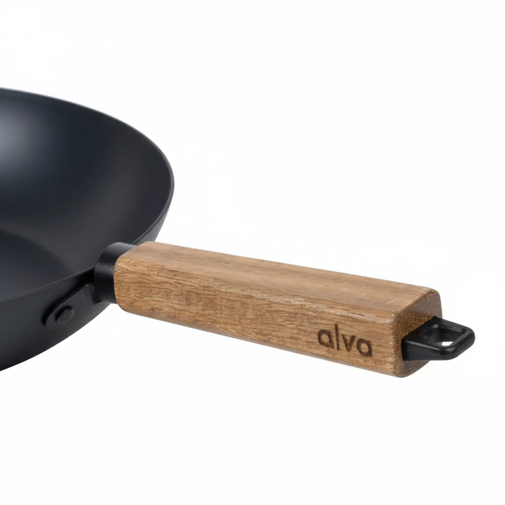 Close-up of the Alva carbon steel wok and branded wooden handle