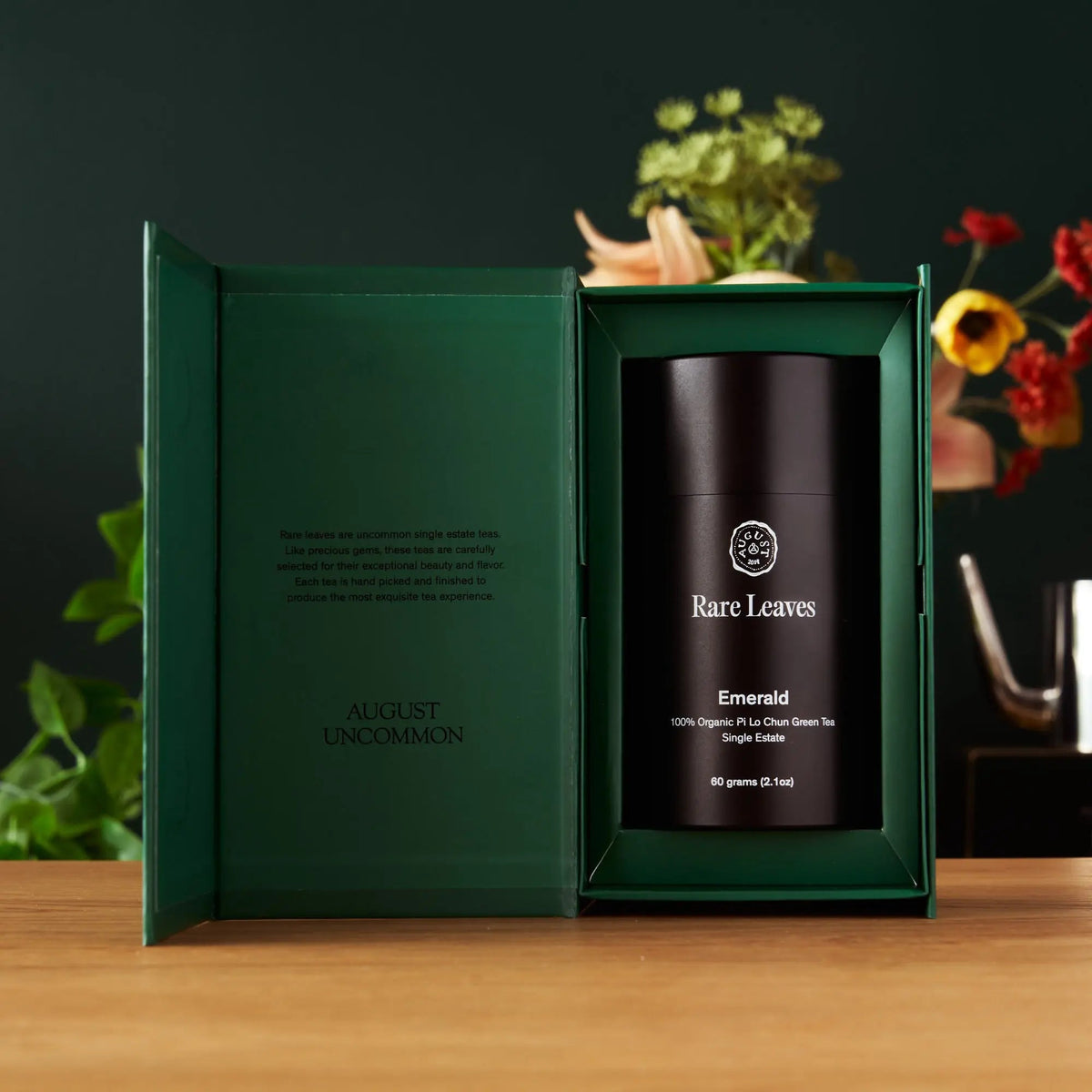 Open August Rare Leaves Emerald gift box displaying premium black aluminum tea tin
