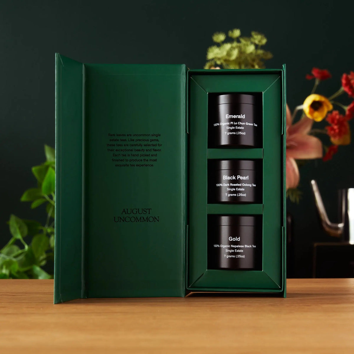 Open August Rare Leaves tea sampler gift box displaying three miniature tea tins

